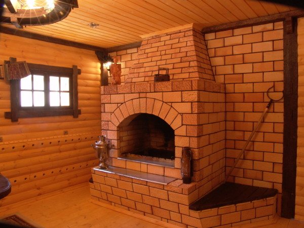 Photo of a brick structure with a remote fireplace in the dressing room (open firebox).