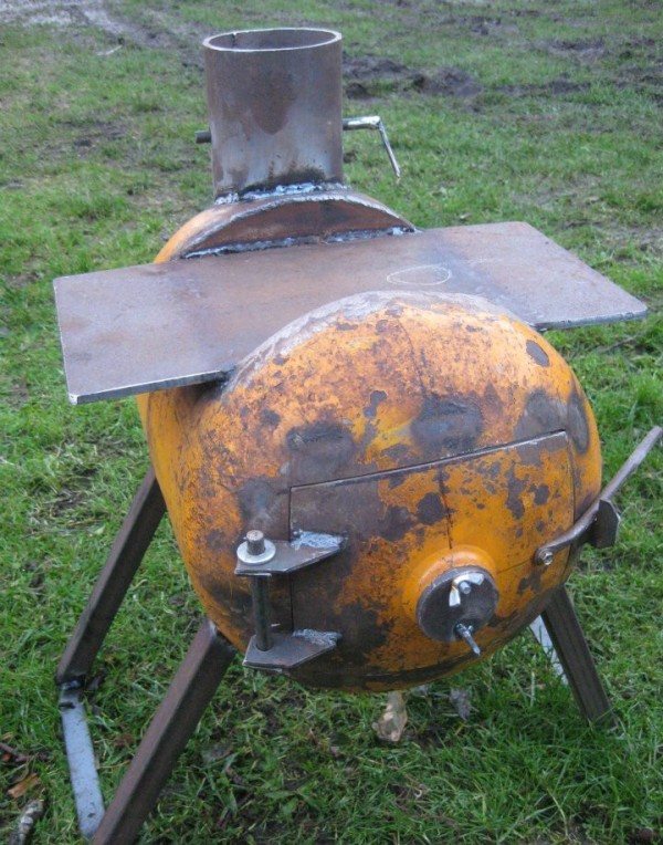 The stove is a potbelly stove made from a gas cylinder. Bath stove made from a metal gas cylinder with a boiler 