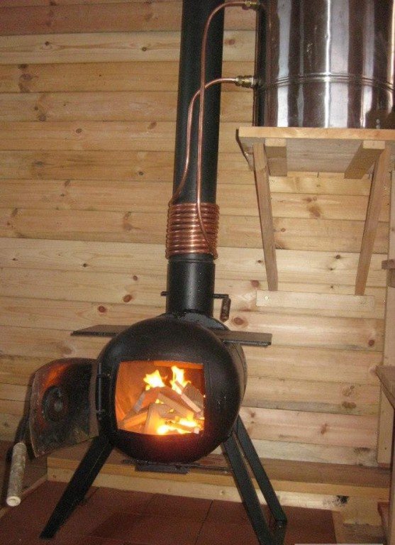 The stove is a potbelly stove made from a gas cylinder. Bath stove made from a metal gas cylinder with a boiler 